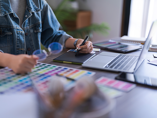 A photographer using a graphics table for photo editing