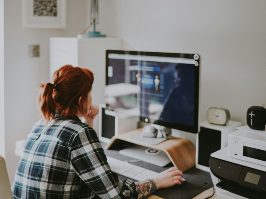 A woman sat at a computer monitor